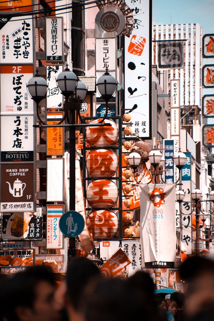 The Art of Drawing Readers In: Your attractive post title goes here Bustling street in Osaka, Japan, filled with vibrant signs and bustling crowds, showcasing the city's lively atmosphere.
